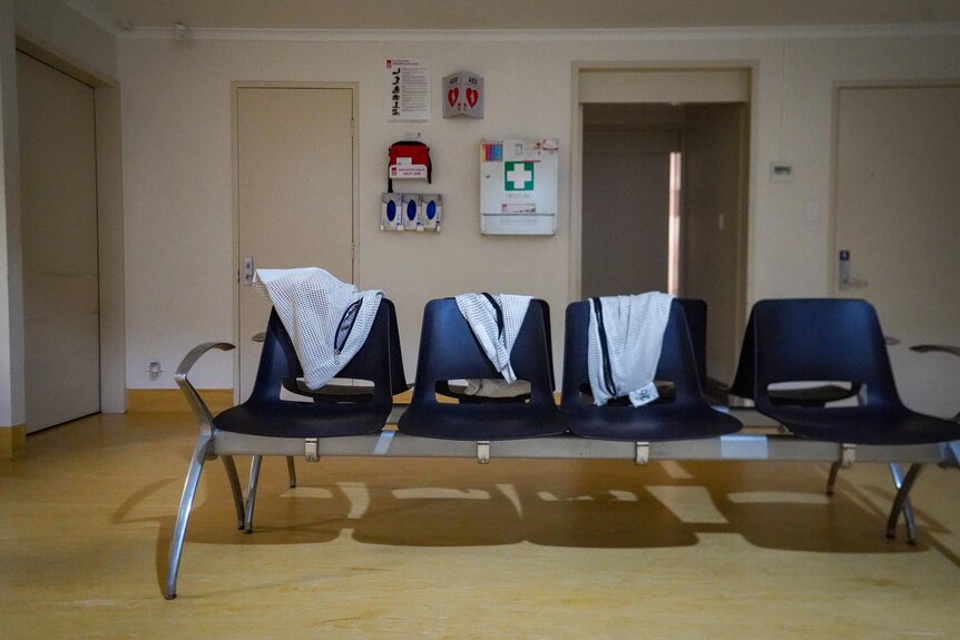 A row of empty chairs inside a room in a sobering-up shelter.