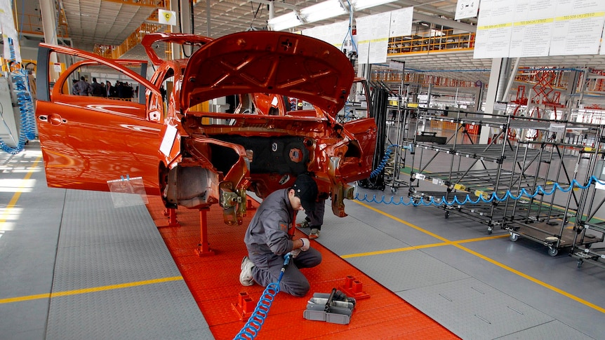 Mechanics work on an assembly line in a car factory of Chinese manufacturer Great Wall Motor Co in Europe. February 2012