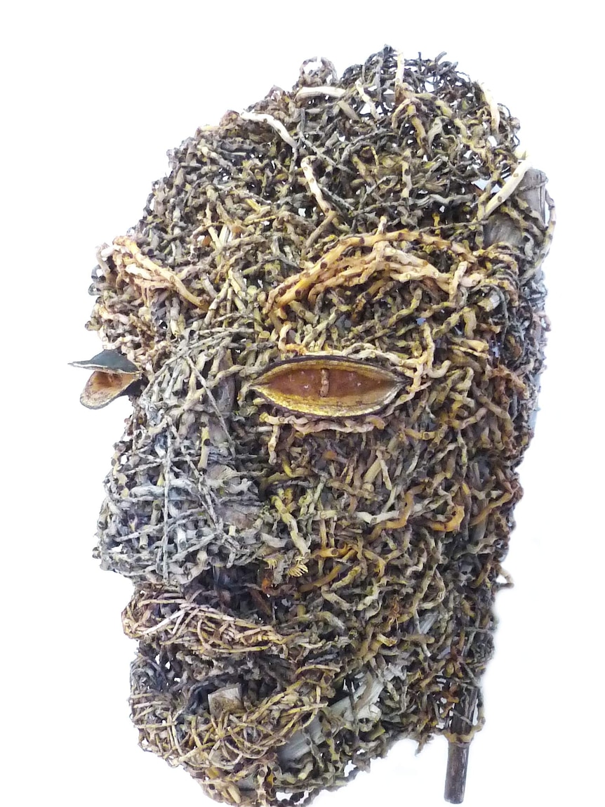 Weaved sculpture of a face using weeds