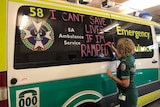 'I can't save lives if I'm ramped' being written on ambulance
