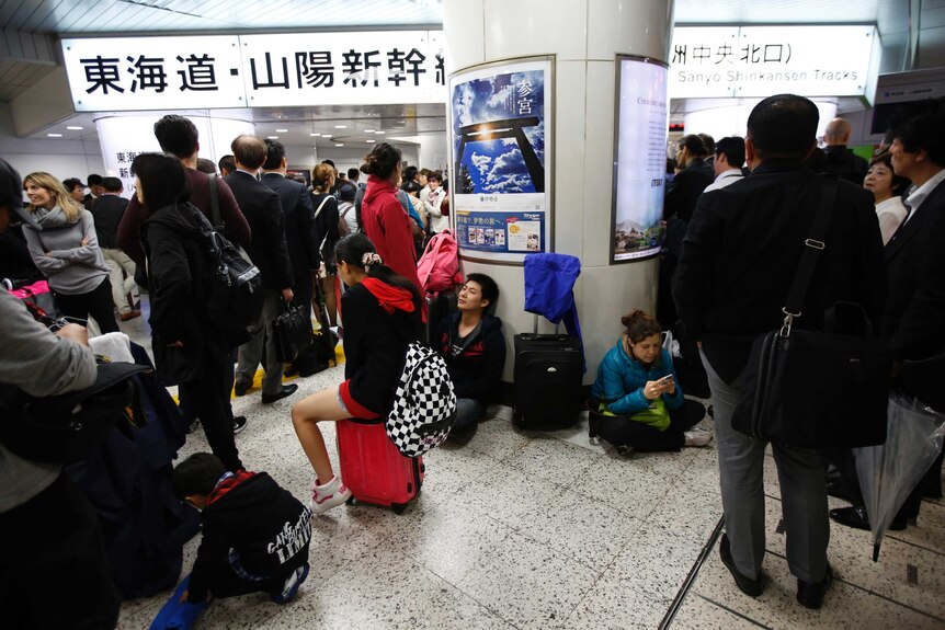 Japanese commuters wait out Typhoon Phanfone