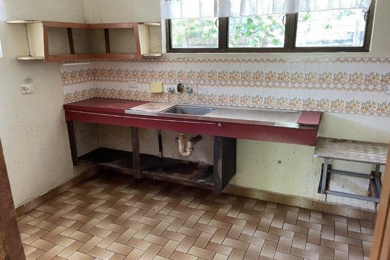 An old kitchen with aged fittings and tiles