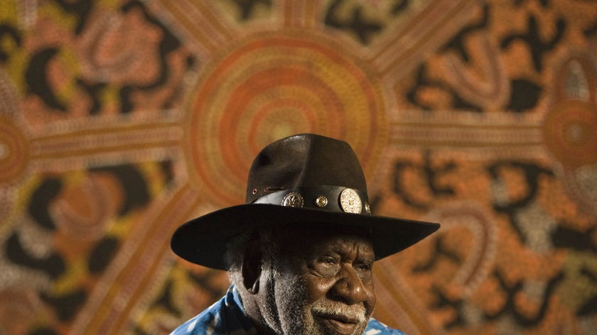 Long Jack Phillipus Tjakamarra sits in front of his work Making Spears