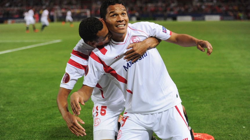 Carlos Bacca of Sevilla (9) celebrates with Timothee Kolodziejczak (15) as as he scores their first goal