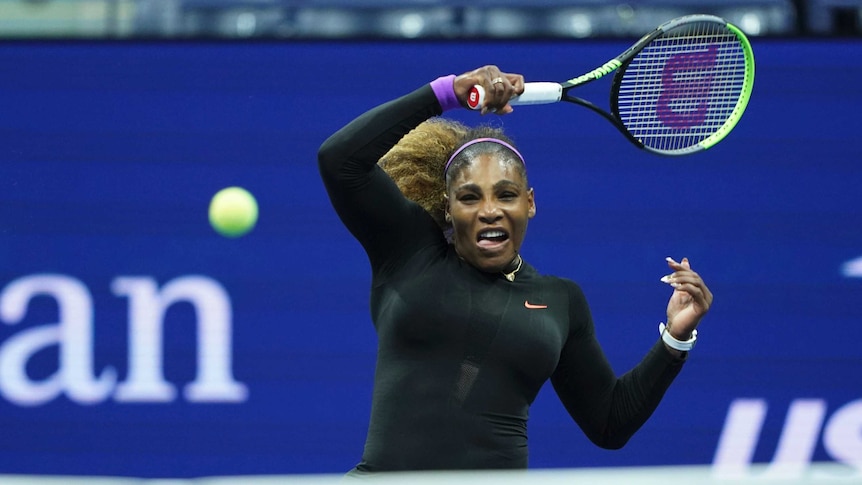 Serena Williams plays a forehand shot with her racquet over her head on the follow-through and the ball coming back to the net
