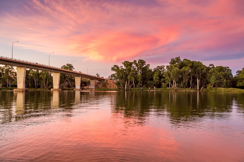 A pink and orange sunset reflected in the Murray River, Mildura
