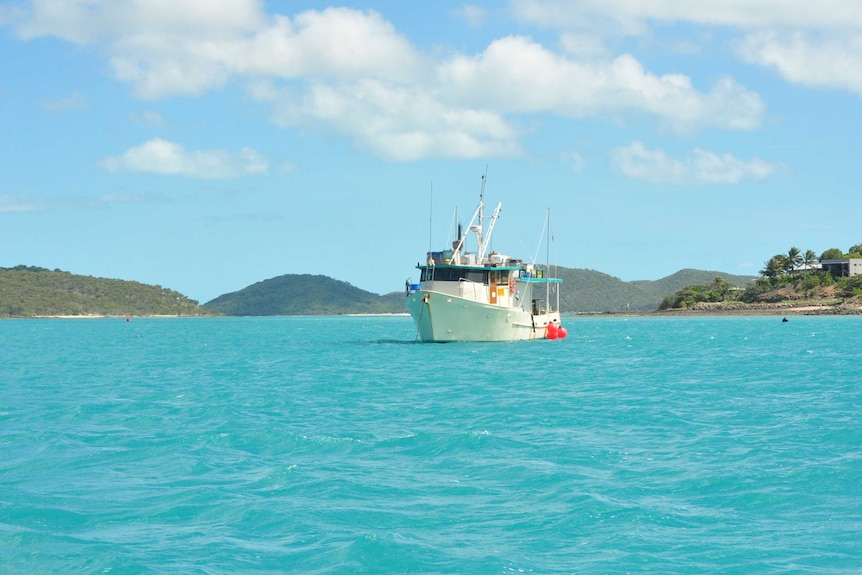 The view from Thursday Island with a boat fishing in the bright sea