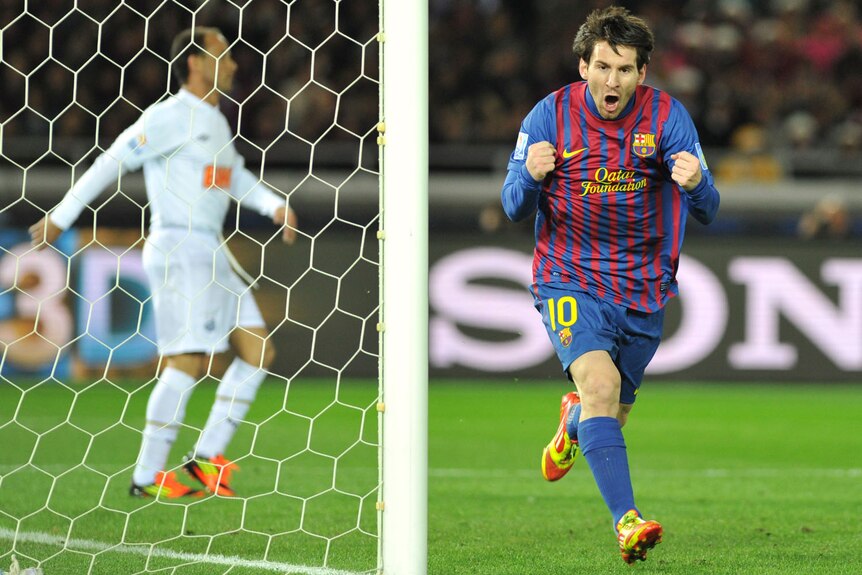 Barcelona striker Lionel Messi (R) celebrates his goal against Santos