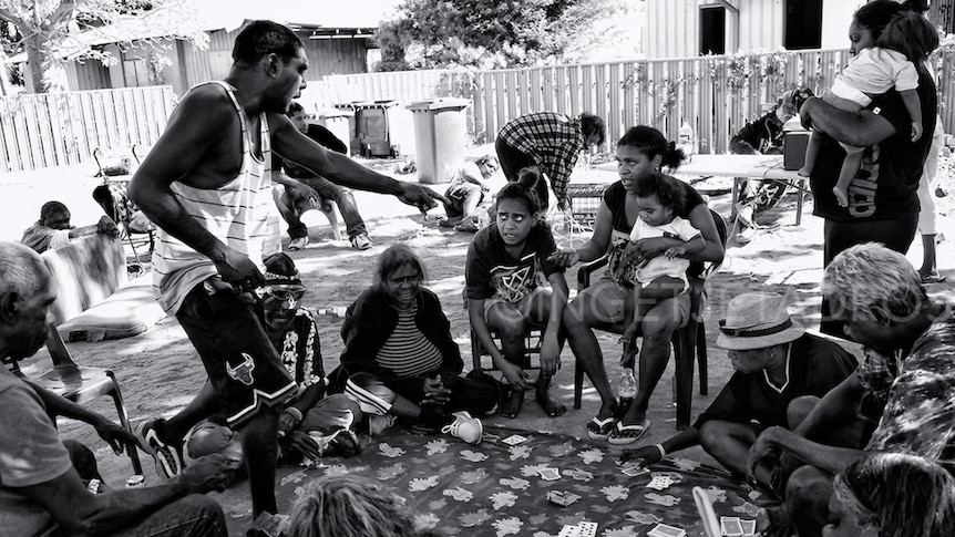 A group of people at Kennedy Hill in Broome playing cards.