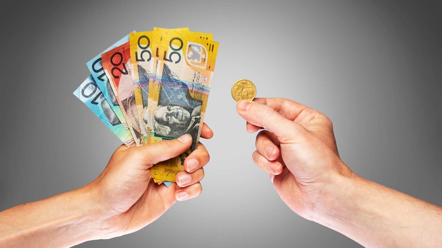 Photo of two hands, one holding a few notes of cash, the other a $1 coin