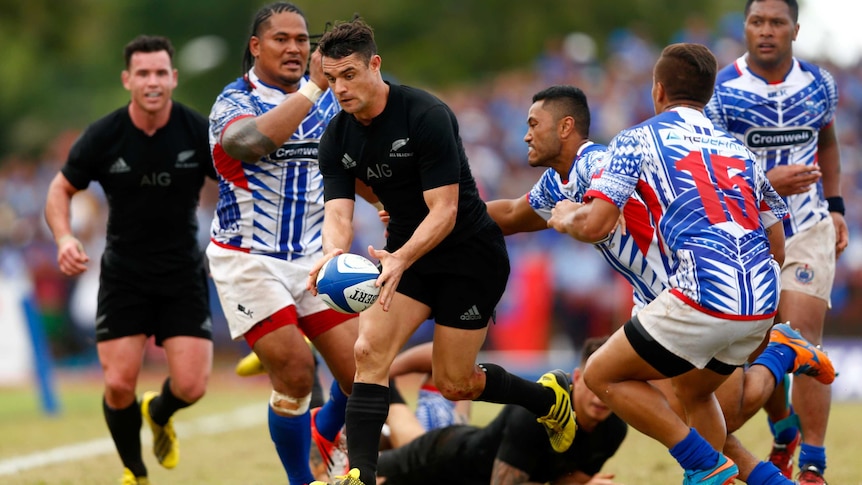 Daniel Carter of the All Blacks takes on Samoa