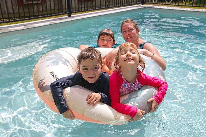 Brisbane single mum Amy Miller with her three children in a swimming pool.