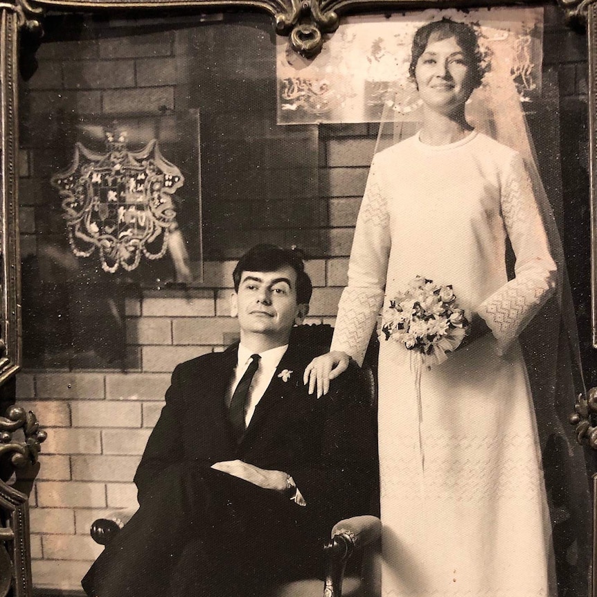 Mike and Wendy Saclier posing in a black and white wedding photo.
