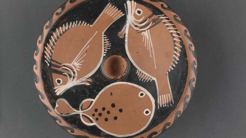 A clay plate with fish motifs
