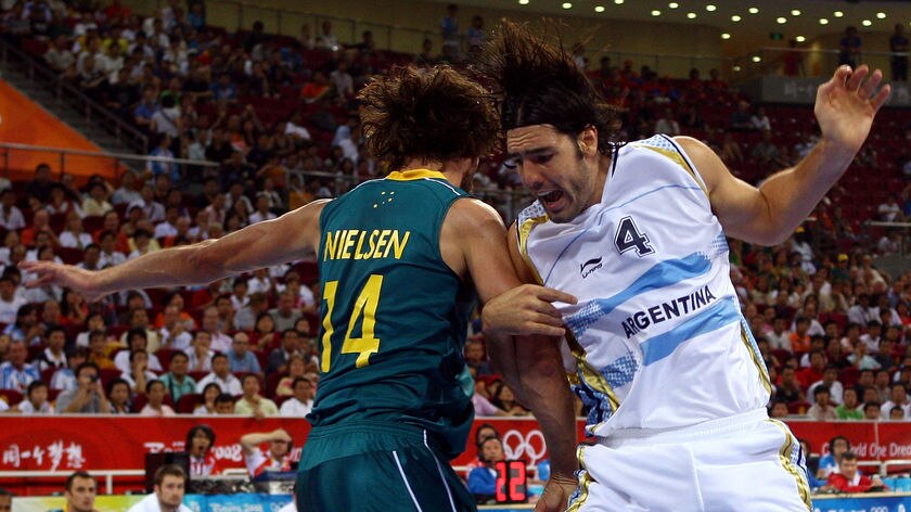 Luis Scola of Argentina is tangled up with Matt Nielson of Australia in the men's basketball