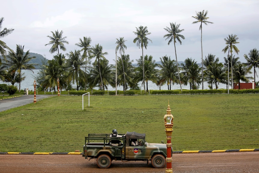 Sailors sit on a truck at the Cambodian Ream Naval Base