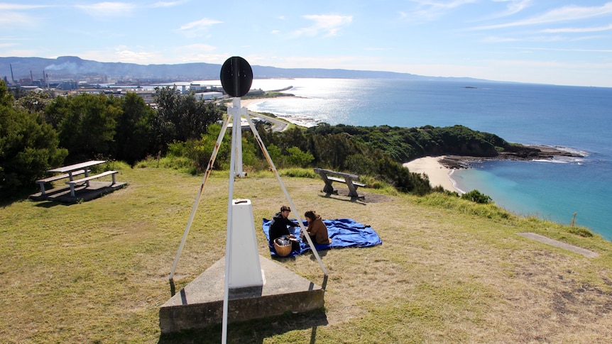 The view looking north from Hill 60 with people having a picnic on the grass.