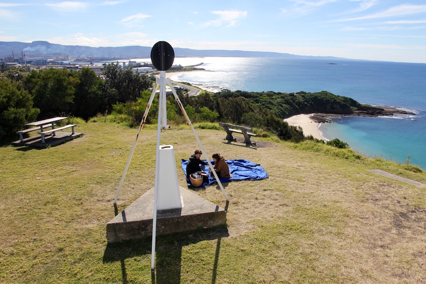 The view looking north from Hill 60 with people having a picnic on the grass.