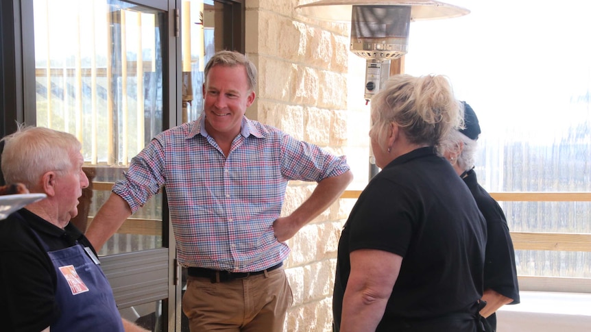 Premier Will Hodgman talking to people at barbecue.