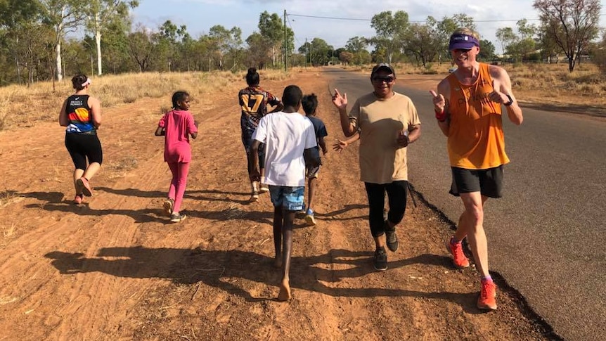 Runners along a road in the bush