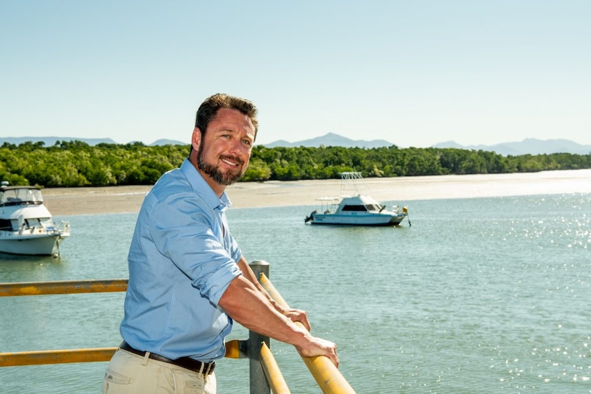 Nick Dametto stands over a waterway.