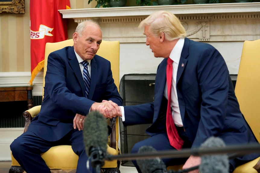 US President Donald Trump shakes hands with John Kelly.