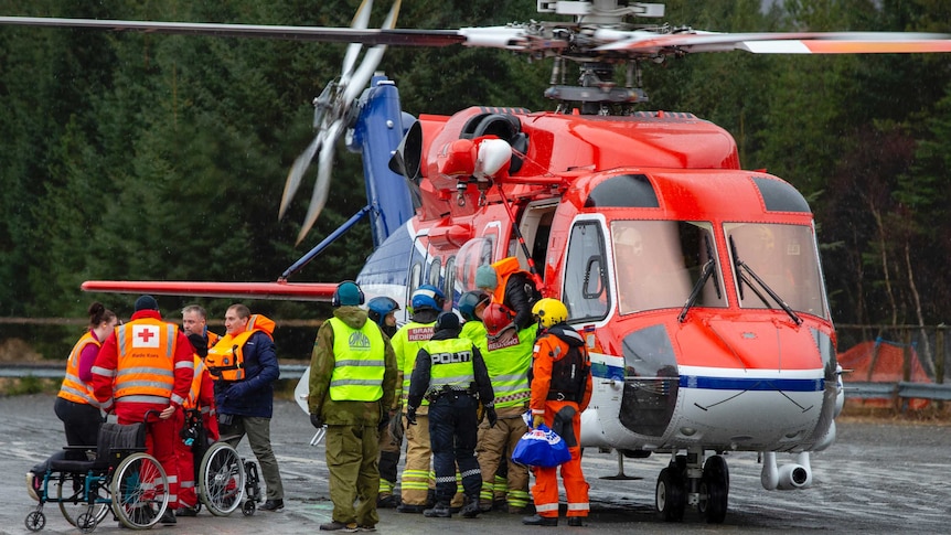 Passengers are helped from a rescue helicopter in Norway after being rescued from the Viking Sky cruise ship. 
