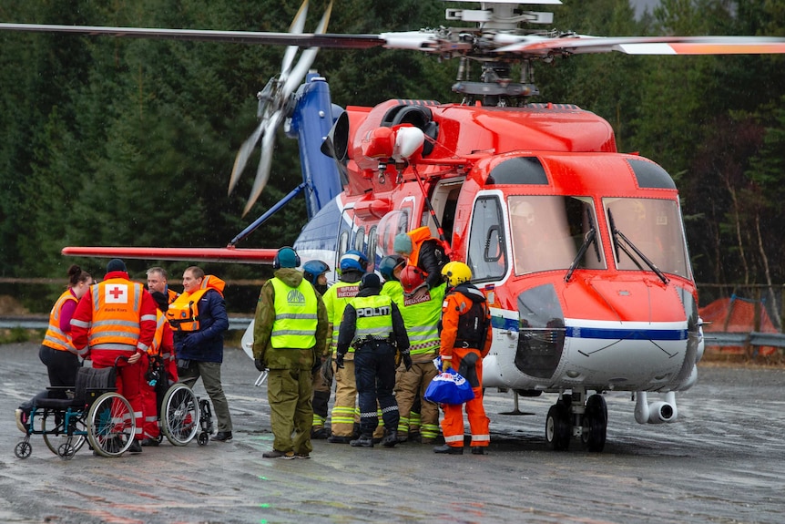 Passengers are helped from a rescue helicopter in Norway after being rescued from the Viking Sky cruise ship. 