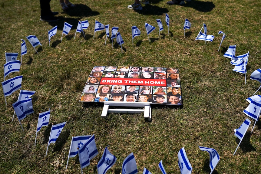 Bring them home sign surrounded by Israel flags