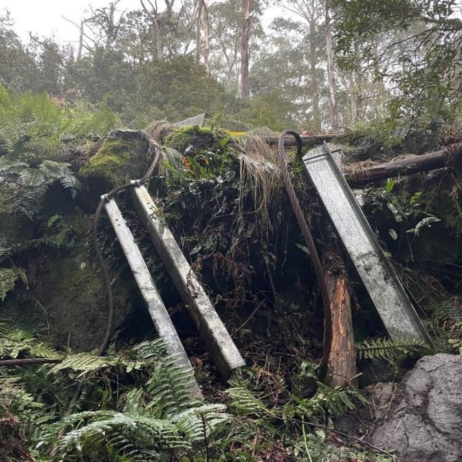 Photo of road barrier posts out of ground after car crash.