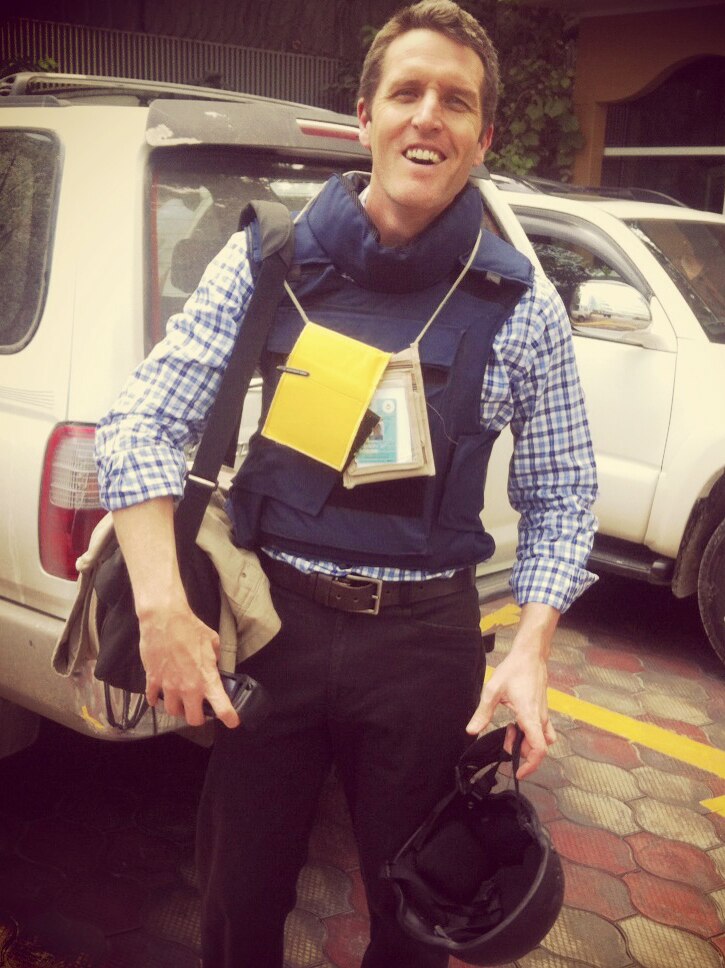 Holding his helmet and in armoured vest is WA election monitor Josh Wilson, in Kabul Afghanistan