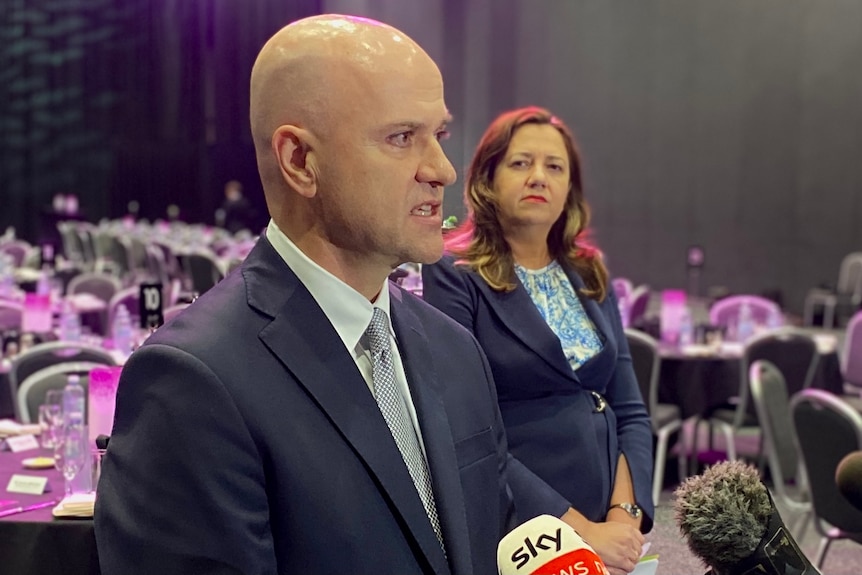 Dr Gerrard speaking at a press conference with Premier Annastacia Palaszczuk in the background.