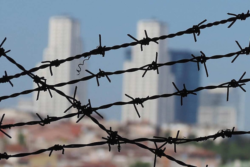 City skyline crossed with barbed wire