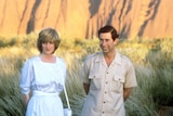 Prince Charles and Princess Diana pose for photos with Uluru as a backdrop.