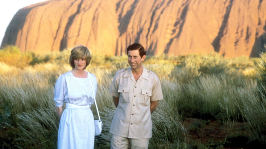 Prince Charles and Diana, Princess of Wales, pose for photos with Uluru as a backdrop.