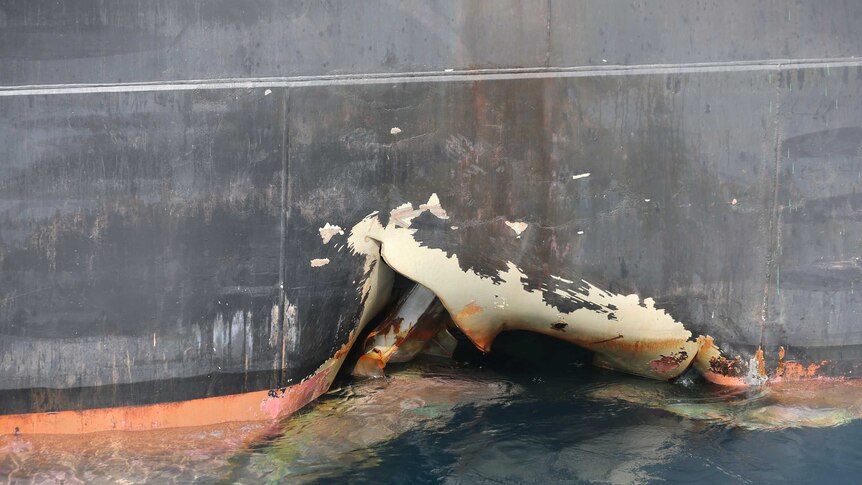 A damaged ship is seen off the Port of Fujairah, United Arab Emirates.