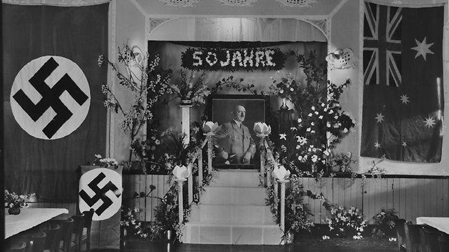 An shrine to Adolf Hitler with a nazi flag on one side and an Australian flag on the other