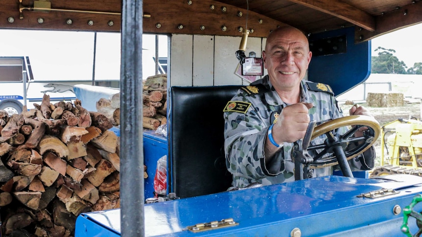 Warrant Officer Ian Waller sits at the helm of a restored steam powered Foden Wagon
