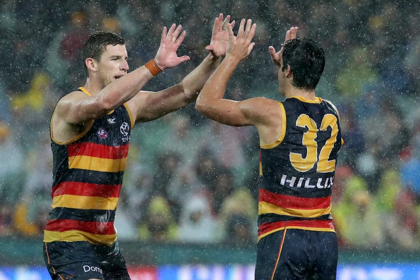 Josh Jenkins and Darcy Fogarty give each other a high five during the Crows' encounter against the Bulldogs.