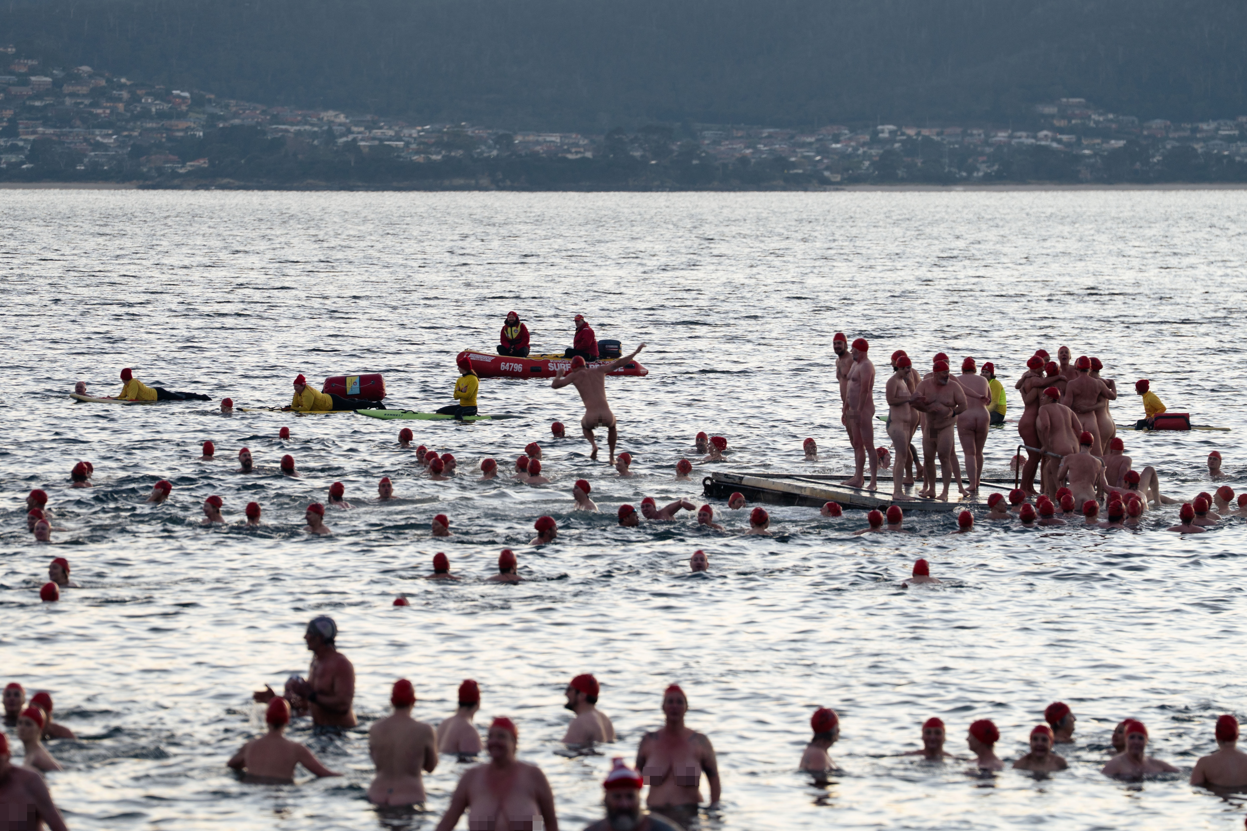 Naked swimmers in the River Derwent water celebrate the end of the longest night of the year for Nude Solstice Swim