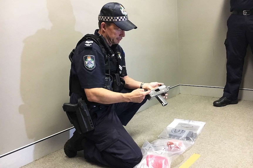 A policeman holding a homemade weapon