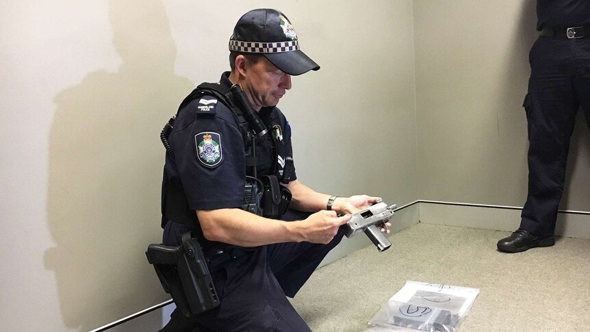 A policeman holding a homemade weapon
