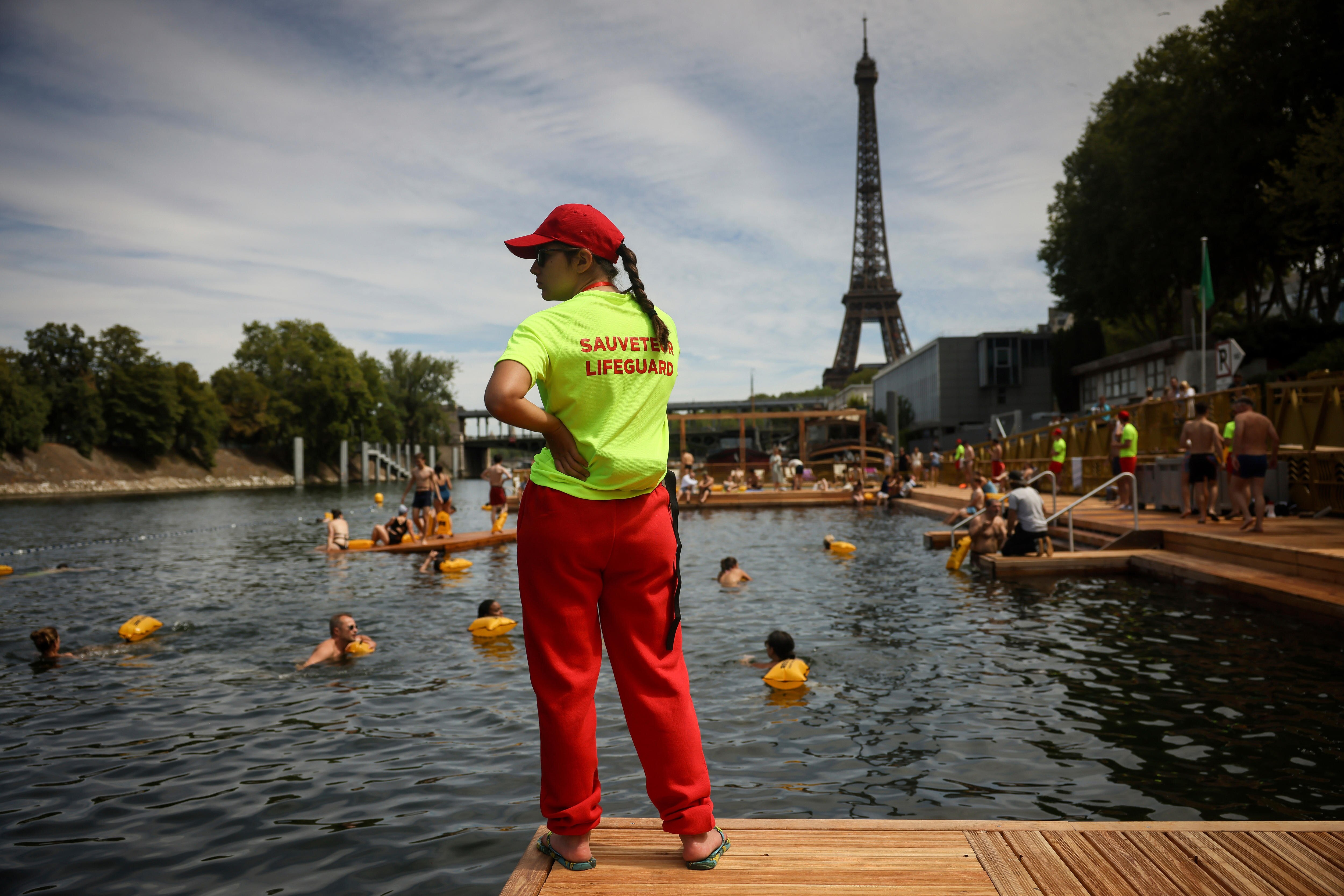A lifeguard watches swimmers in the Seine river