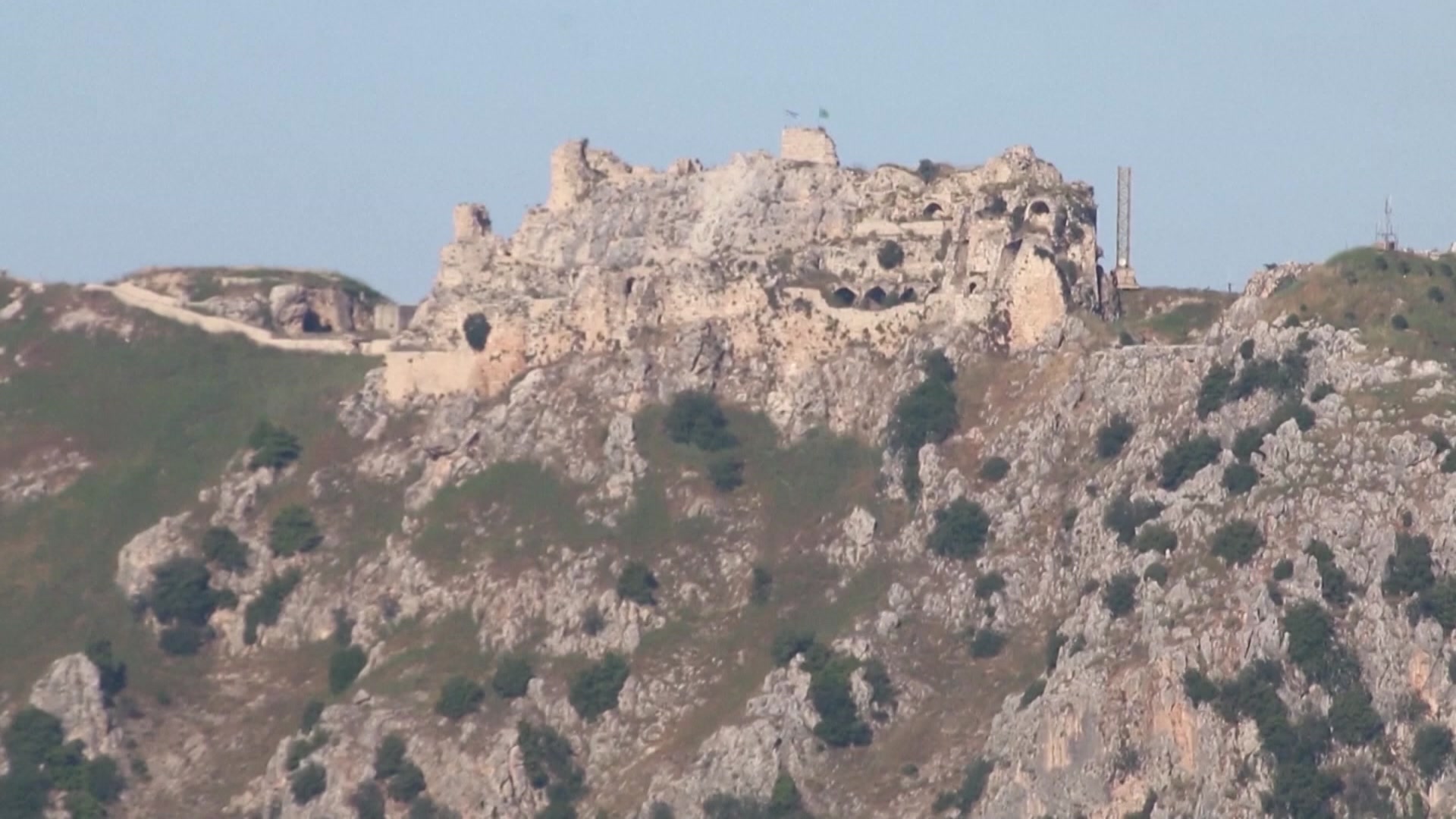 The ruins of a castle on top of a hill