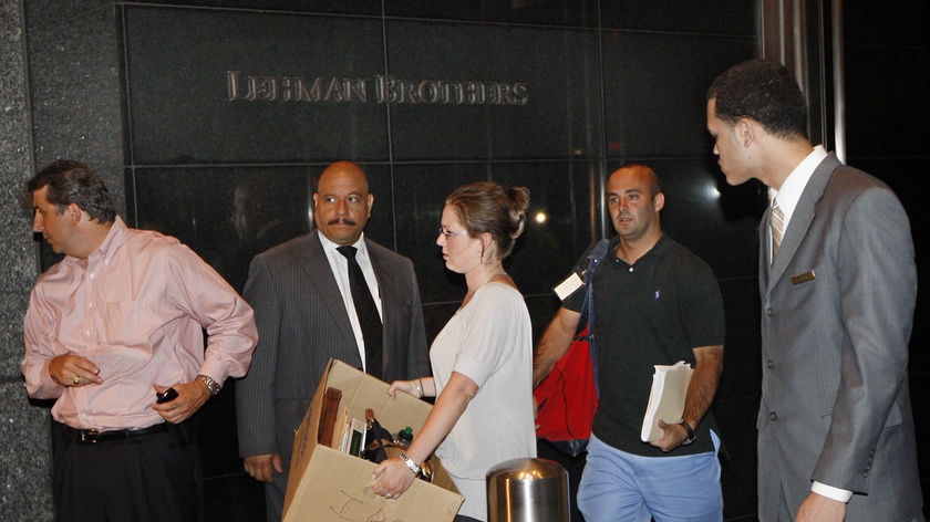 People walk out of the Lehman Brothers building in New York carrying their belongings.