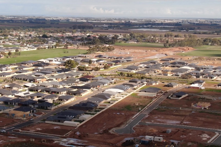 New houses and roads with dirt from the air