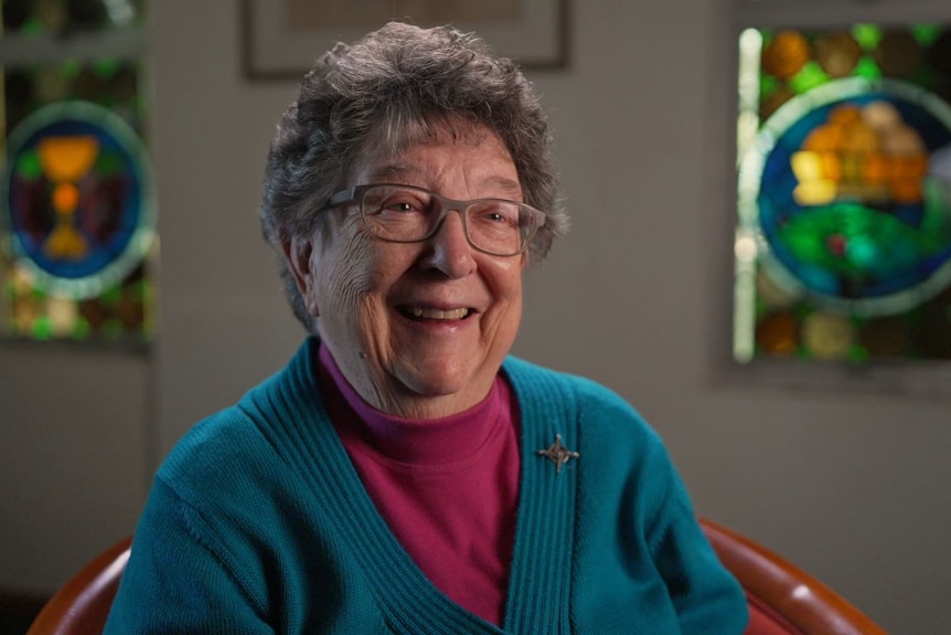 An elderly woman smiling happily