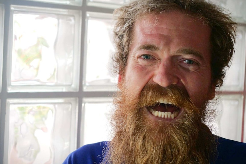 Portrait of man with long blond beard smiling