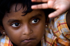 A young Sri Lankan girl looks up as asylum seekers engage in a hunger strike, at Cilegon on October 16, 2009 in Merak, Java, ...