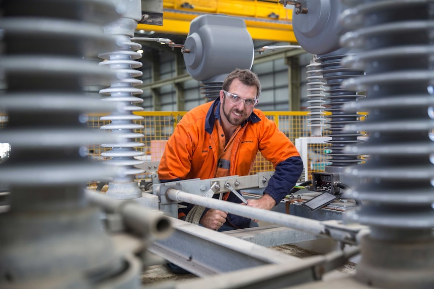 An Ampcontrol worker tightens a bolt on one of the company's transformers at a factory in the NSW Hunter Valley.